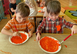 chłopcy malują farbami