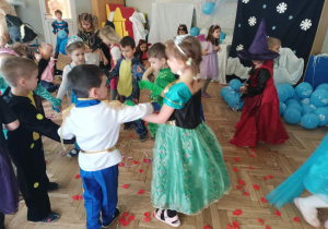 Dzieci tańczą w kole.